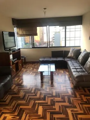 a living room with a couch and a table at Host, Apartment for rent in Lima