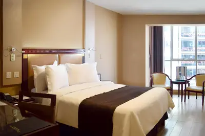 a hotel room with a large bed and a window at Gran Mundo Hotel & Suites in Lima