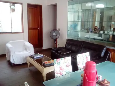 a living room with a couch and a chair at Hospedaje La Anita in Lima