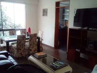 a living room with a couch and a tv at Hospedaje La Anita in Lima