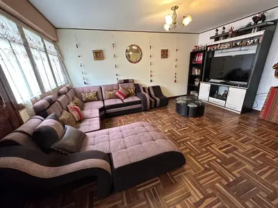 a living room with a couch and a flat screen tv at Euler House`s in Cusco