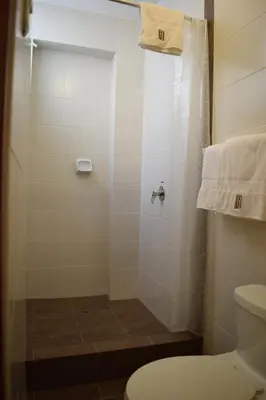 a bathroom with a shower and a toilet at Illariy Hotel in Huancavelica