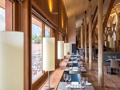 a row of tables in a restaurant with lamps at Explora Valle Sagrado in Urubamba