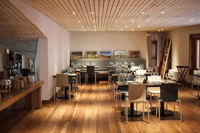 a restaurant with tables and chairs in a room at Explora Valle Sagrado in Urubamba