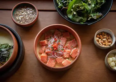 a wooden table with bowls of food on it at Explora Valle Sagrado in Urubamba