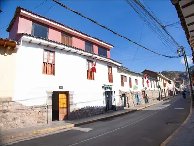 a street with a white building on the side of the road at Casa de Laura in Cusco