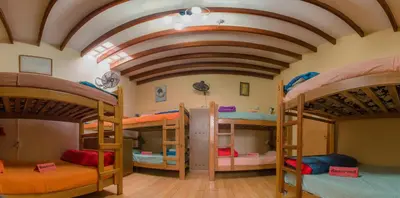 a room with three bunk beds in it at Waikiki Hostel in Lima