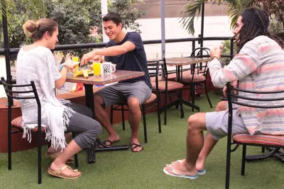 a group of people sitting at a table at Waikiki Hostel in Lima