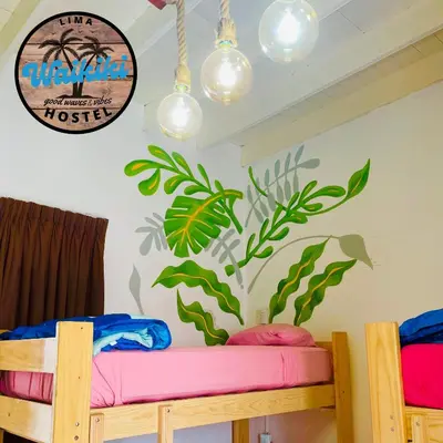 a room with two bunk beds with a mural on the wall at Waikiki Hostel in Lima