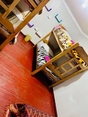 an overhead view of a room with bunk beds at Ukumari Hostel in Cusco