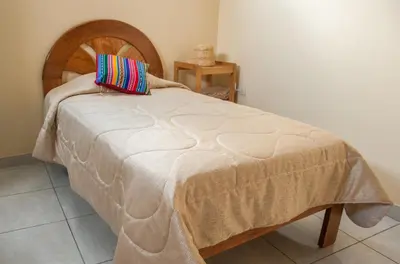 a bed with a pillow on top of it at B&B Valcava in Urubamba