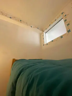 a bedroom with a bed and a window with stars on the wall at Hostal Chaska Wasi in Ollantaytambo