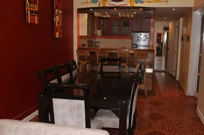 a dining room with a glass table and chairs at Suspiros del Inka in Lima