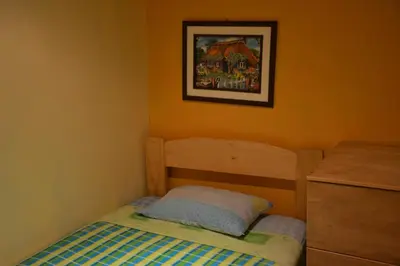 a small bedroom with a bed and a picture on the wall at Suspiros del Inka in Lima