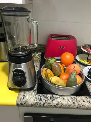 a bowl of fruit on a counter next to a blender at Edificio California en Centro Historico in Lima