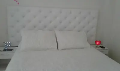 a white bed with two pillows in a bedroom at Edificio California en Centro Historico in Lima
