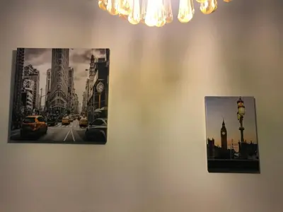 two pictures on a wall with a picture of a city at Edificio California en Centro Historico in Lima