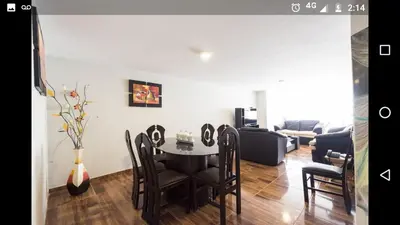 a living room with a table and chairs and a couch at Apartment Miraflores Pardo in Lima