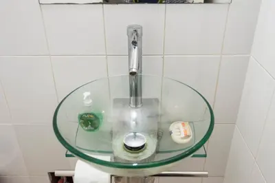 a glass sink in a bathroom with a faucet at Apartment Miraflores Pardo in Lima