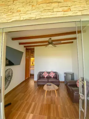 a living room with a couch and a table at Hotel Resort Thiago in Chincha Alta