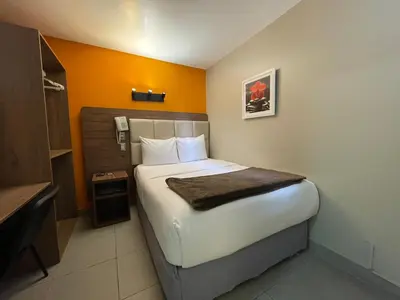 a bedroom with a large bed in a room at Residencial Alfa Hotel in Lima