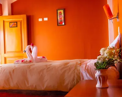 a room with a bed with a swan on it at Peru Quechua's Lodge Ollantaytambo in Ollantaytambo