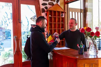 two men standing at a counter in a barber shop at Peru Quechua's Lodge Ollantaytambo in Ollantaytambo