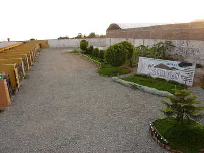 a walkway leading to a stadium with chairs and trees at Motel Sahara Suites in Barranca