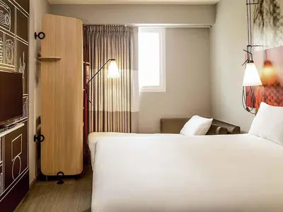 a bedroom with a large white bed and a window at ibis Lima Reducto Miraflores in Lima