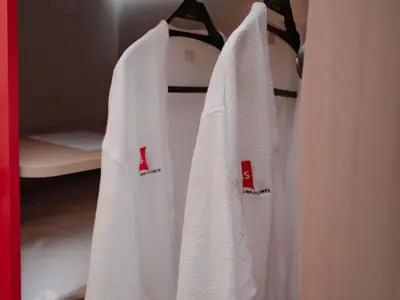 a group of white towels hanging on a rack at ibis Lima Reducto Miraflores in Lima