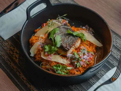 a pan filled with food on a table at ibis Lima Reducto Miraflores in Lima