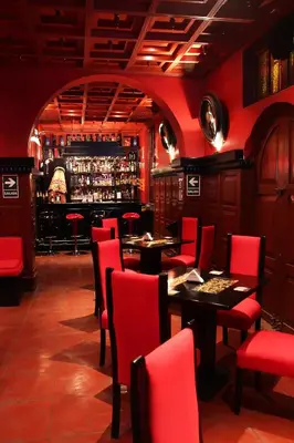 a restaurant with red chairs and tables and a bar at Hotel de Turistas Abancay in Abancay
