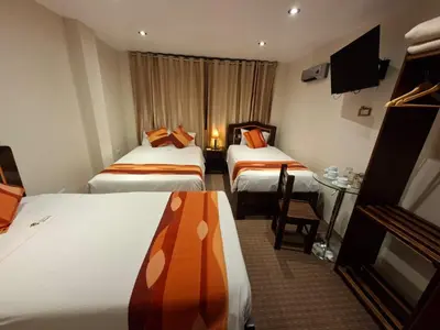 a hotel room with two beds and a table at Andino Classic in Machu Picchu