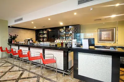 a bar with red chairs at a restaurant at Hilton Garden Inn Lima Surco in Lima