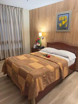 a hotel room with a large bed in a room at Hotel Asturias Inn in Lima