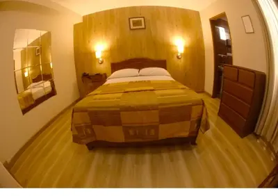 a bedroom with a large bed in a room at Hotel Asturias Inn in Lima