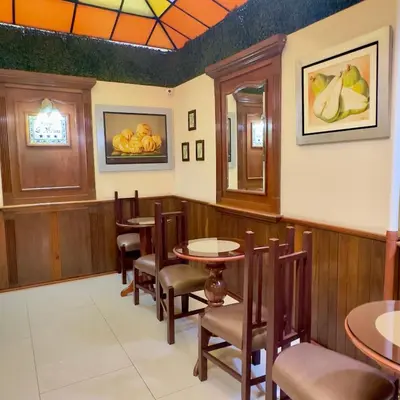 a dining room with tables and chairs in a restaurant at Hotel La Molina in Lima