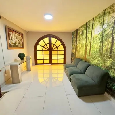 a living room with a couch and a window at Hotel La Molina in Lima