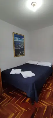 a bedroom with a bed with two towels on it at Apartamento Marco Airport in Lima