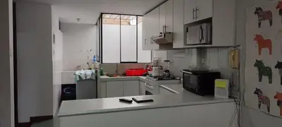 a kitchen with white cabinets and a counter top at Apartamento Marco Airport in Lima