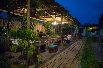 a backyard with a pergola at night at The Upcycled Hostel in Ica