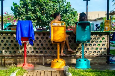 a group of three colorfulools in front of a fence at The Upcycled Hostel in Ica