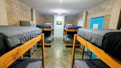 a room with four bunk beds in a room at The Upcycled Hostel in Ica