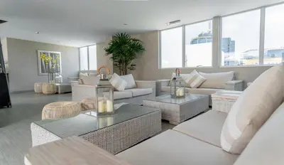 a living room with couches and tables and windows at Jose Antonio Deluxe in Lima