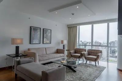 a living room with a couch and a table and chairs at Jose Antonio Deluxe in Lima
