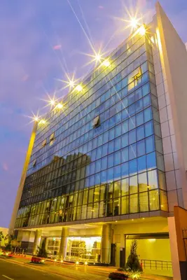 a tall building with lights on top of it at Jose Antonio Deluxe in Lima