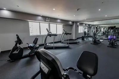 a gym with several treadmills and exercise bikes at Jose Antonio Deluxe in Lima