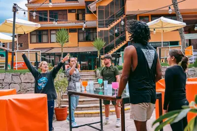 a group of people standing around a table at Wild Rover Cusco in Cusco