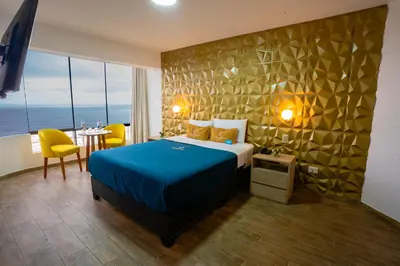 a hotel room with a bed and a table and chairs at Golden Mar Hotel in Lima