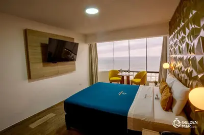 a hotel room with a bed and a view of the ocean at Golden Mar Hotel in Lima